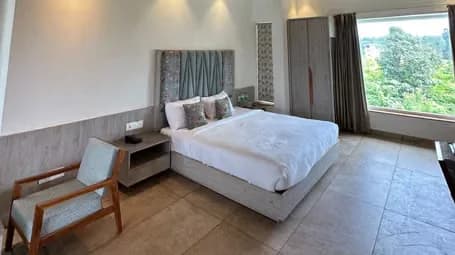 Cottage Room with Daybed, Wooden Ceiling, and Garden View