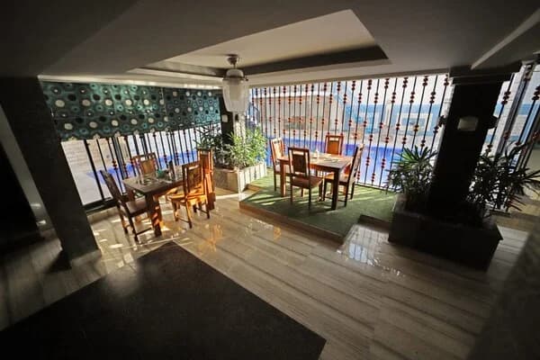 Indoor dining space with pool view